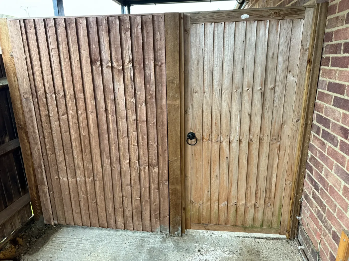 Closeboard fencing installation with capping rail along the top