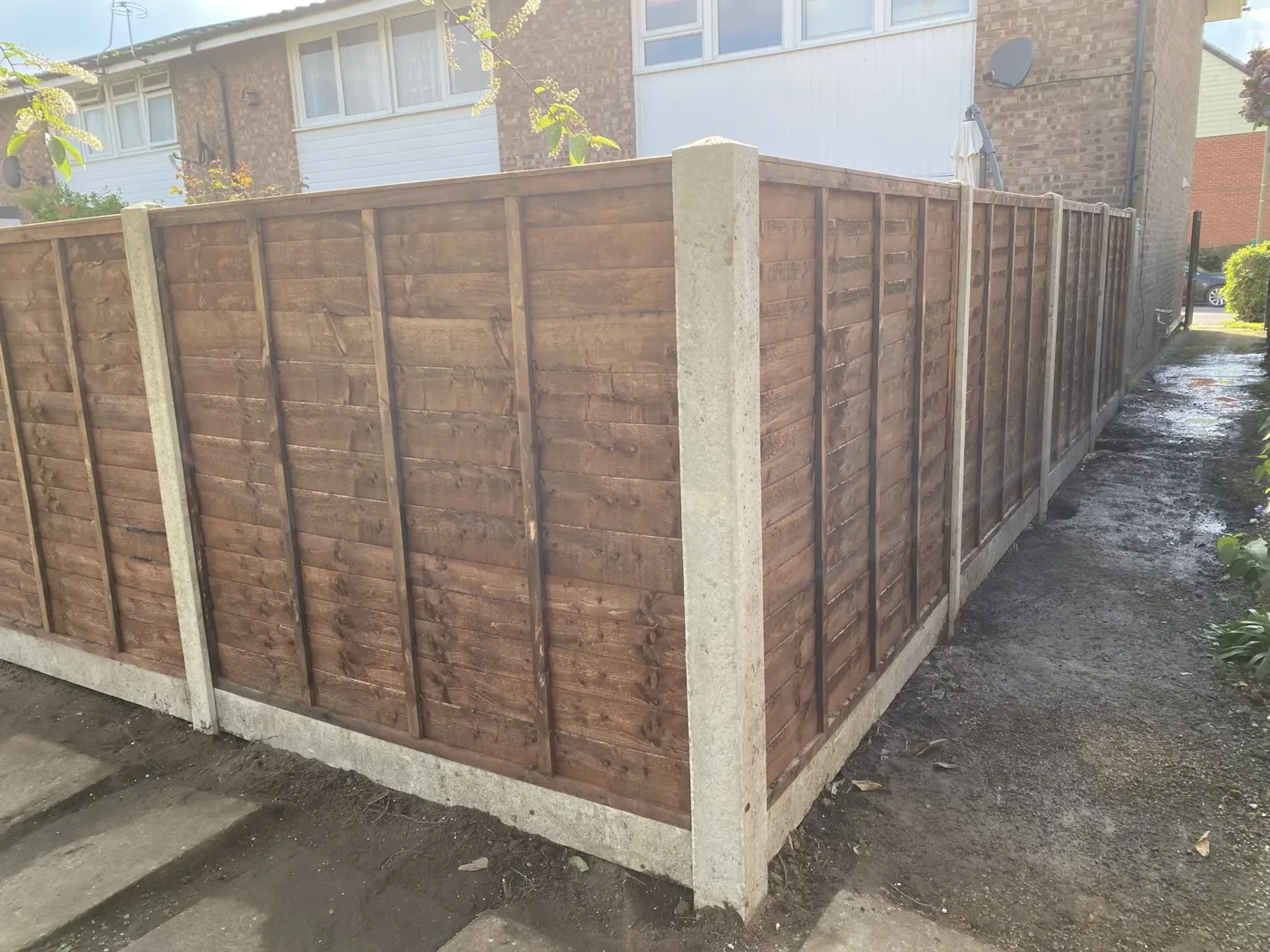 Replacement garden fence panels along a patio boundary