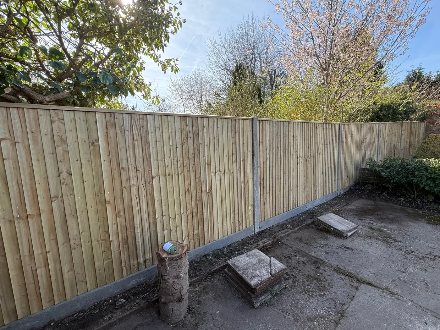Closeboard feather edge fence with concrete posts and gravel boards
