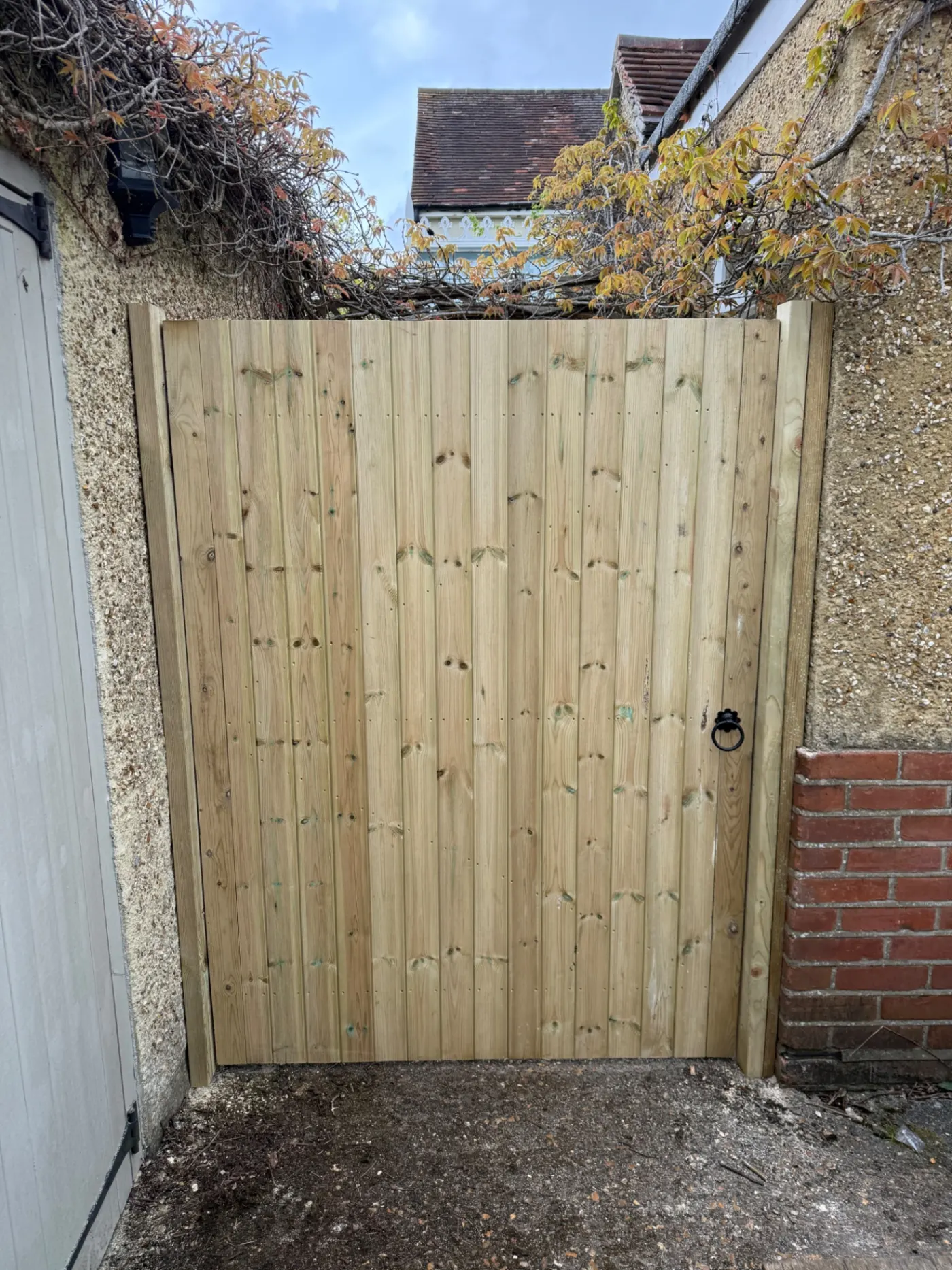 Tongue and groove timber side gate fitted between walls