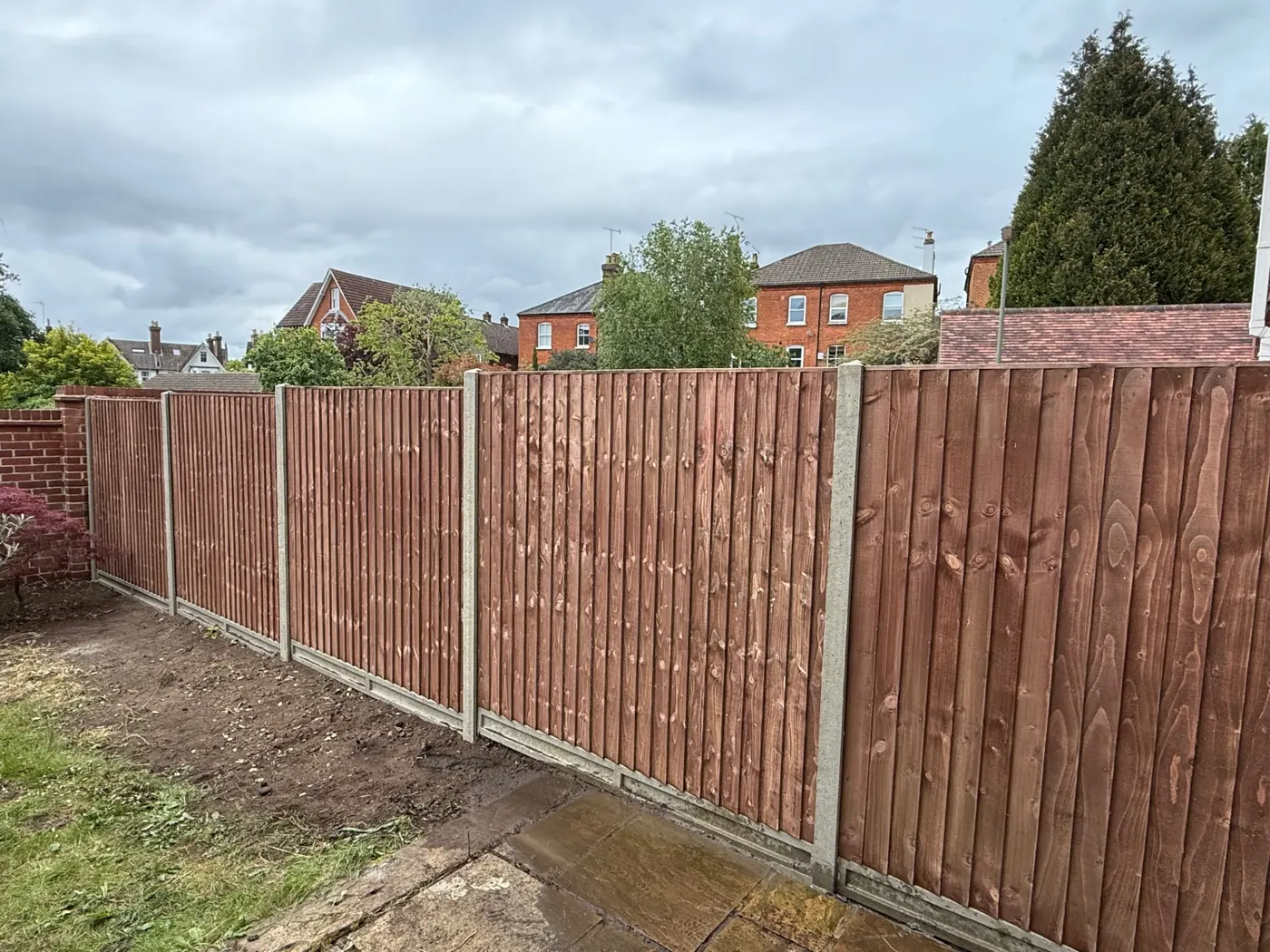 Feather edge fencing with concrete posts and gravel boards