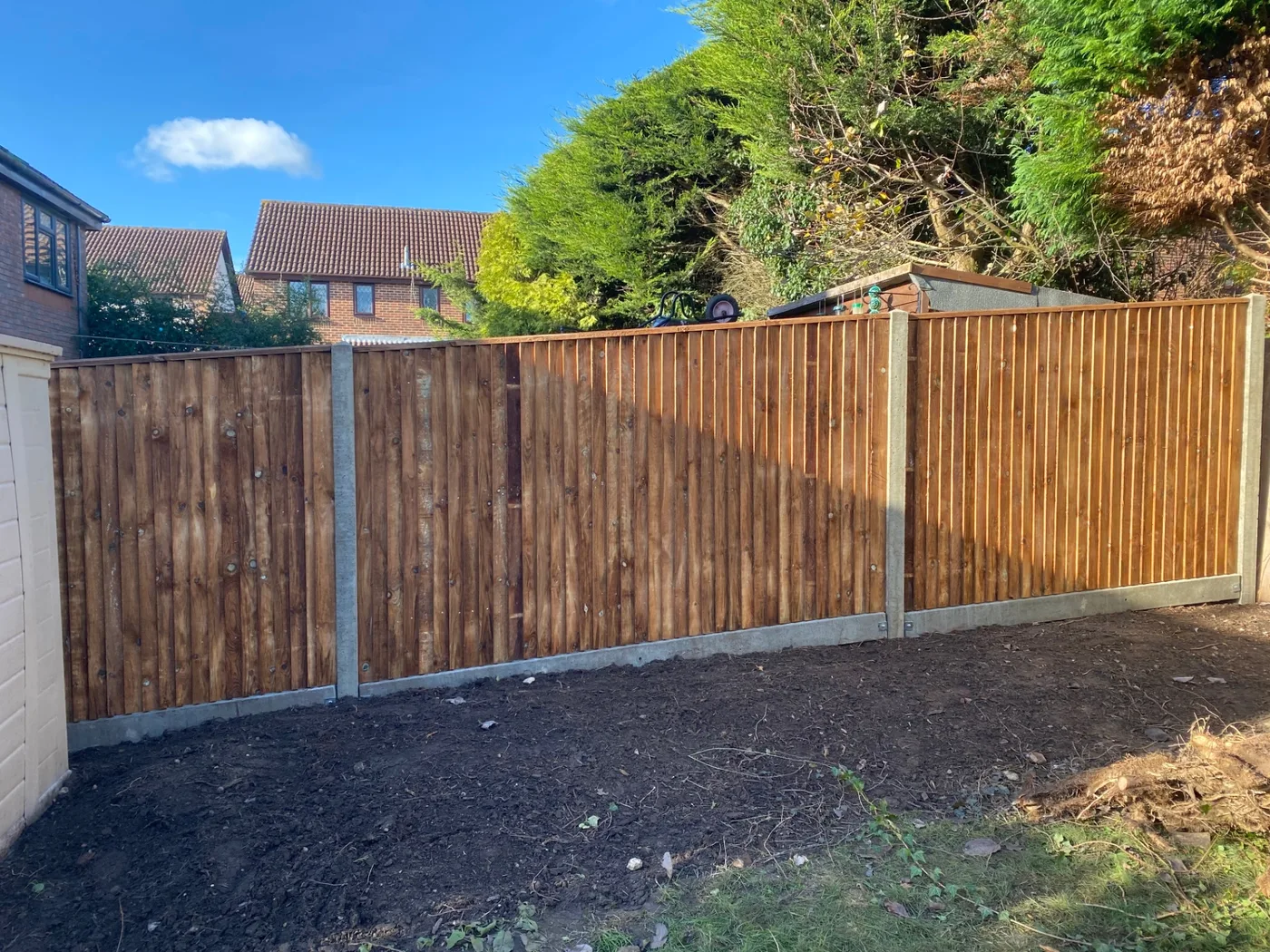 Closeboard feather edge fence panels with concrete posts