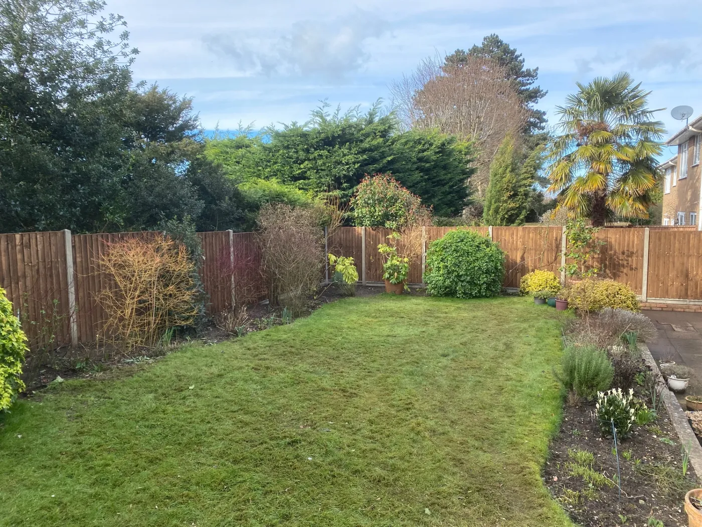Full garden boundary fence installation around a lawn