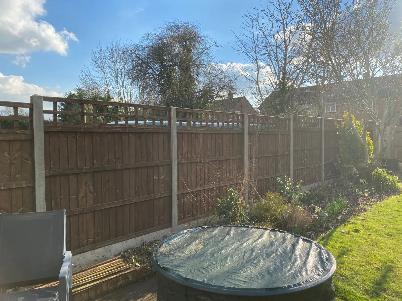 Trellis topped fence panels installed between concrete posts