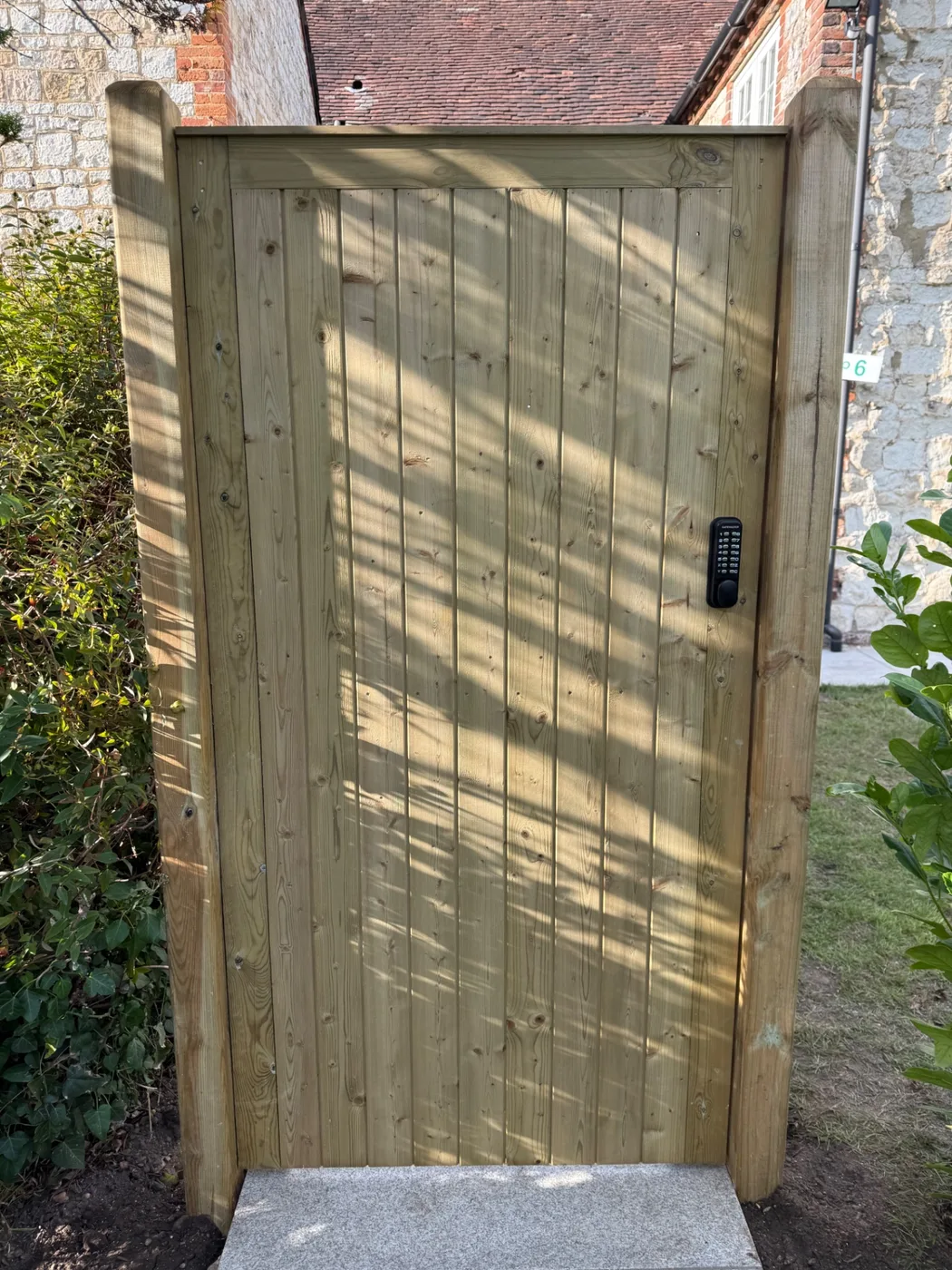 Tongue and groove side gate fitted with a keypad lock