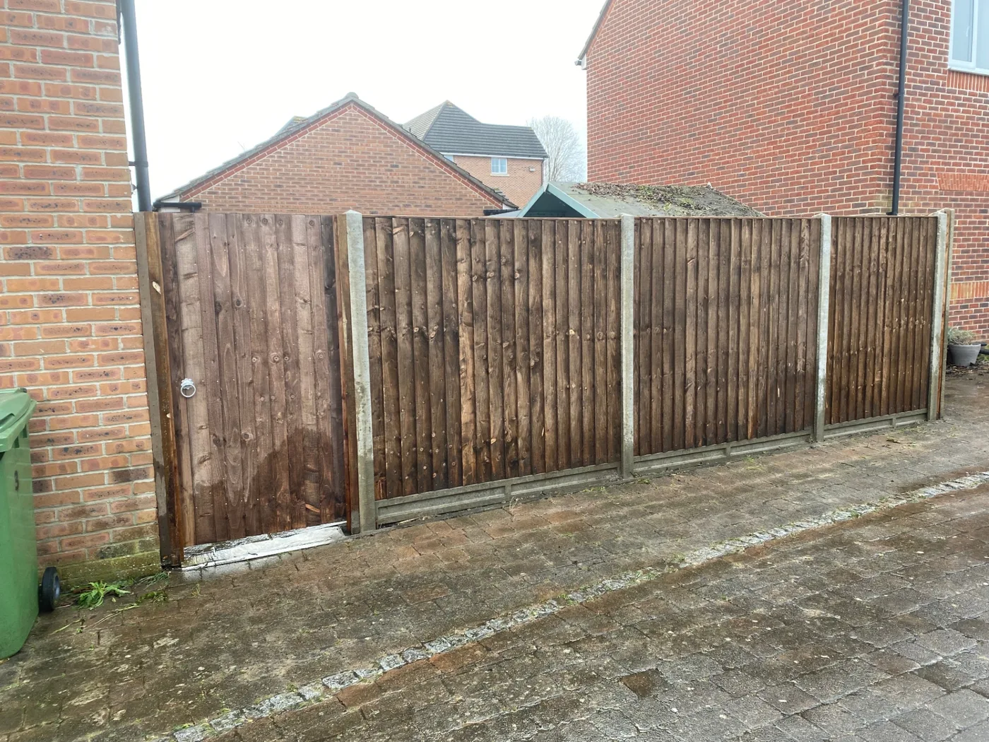 Brown stained side gate matched to closeboard fence panels