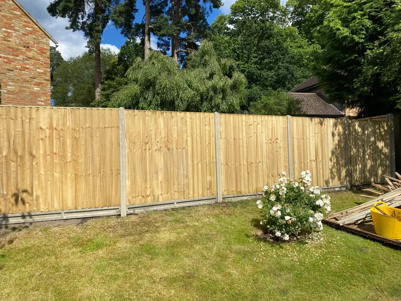 Replacement garden fencing with stepped panels on sloping ground
