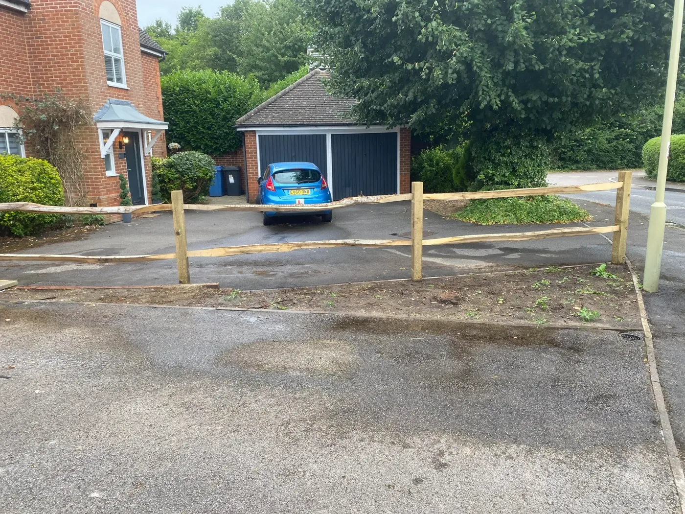 Fence installation with newly set posts along a cleared fence line