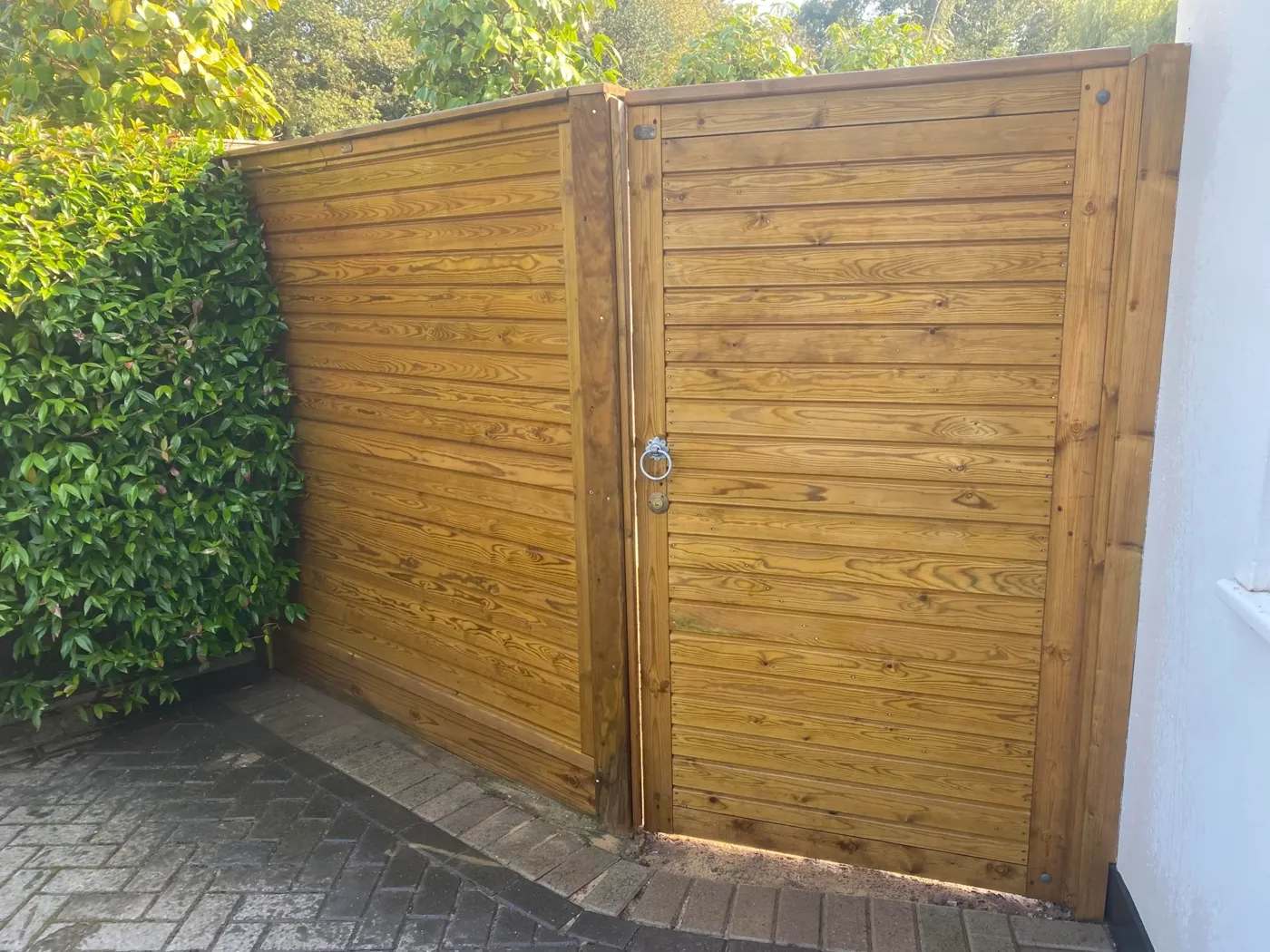 Tongue and groove timber garden gate hung on new posts