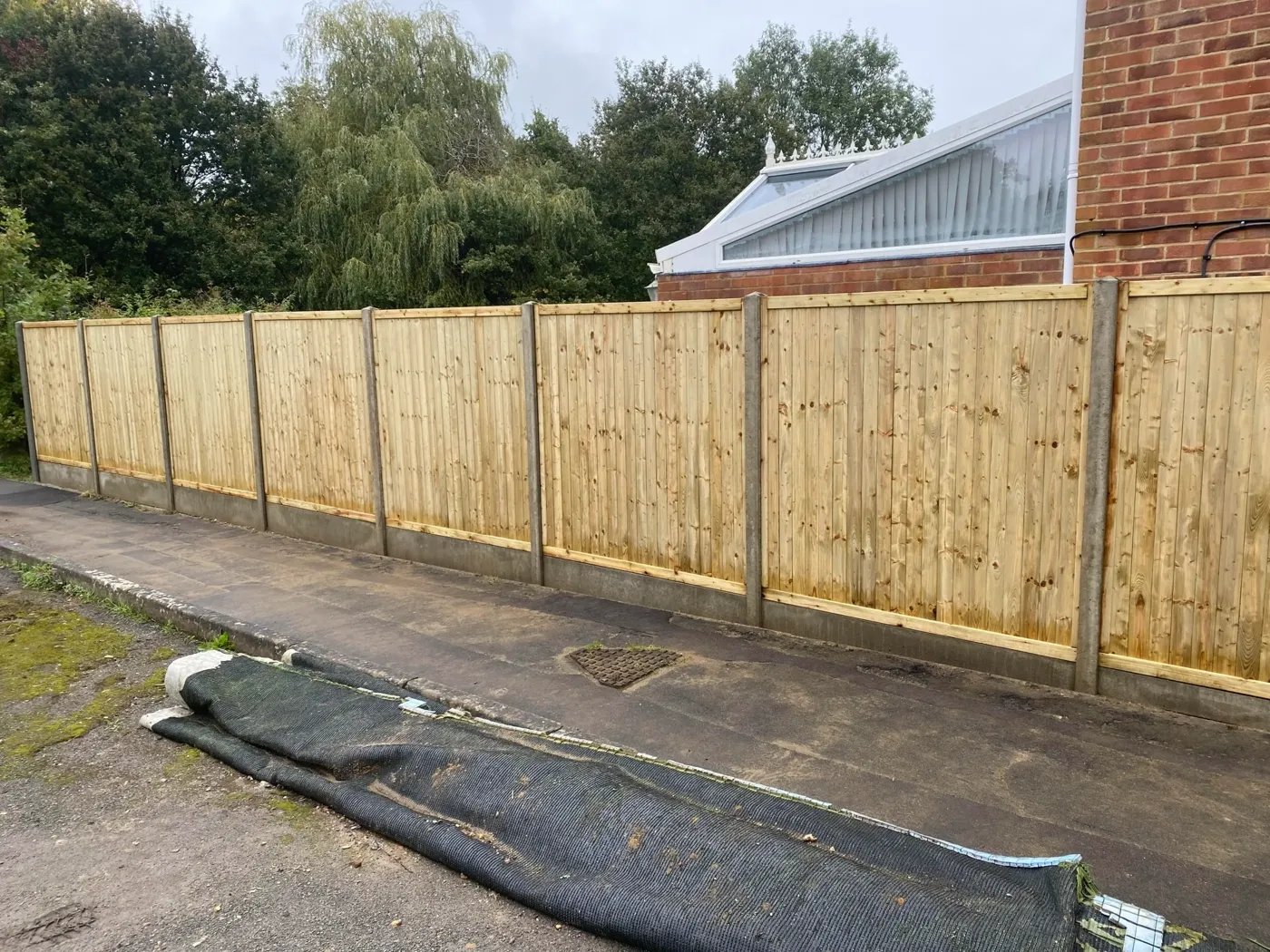 Tongue and groove fence panels fitted between timber posts
