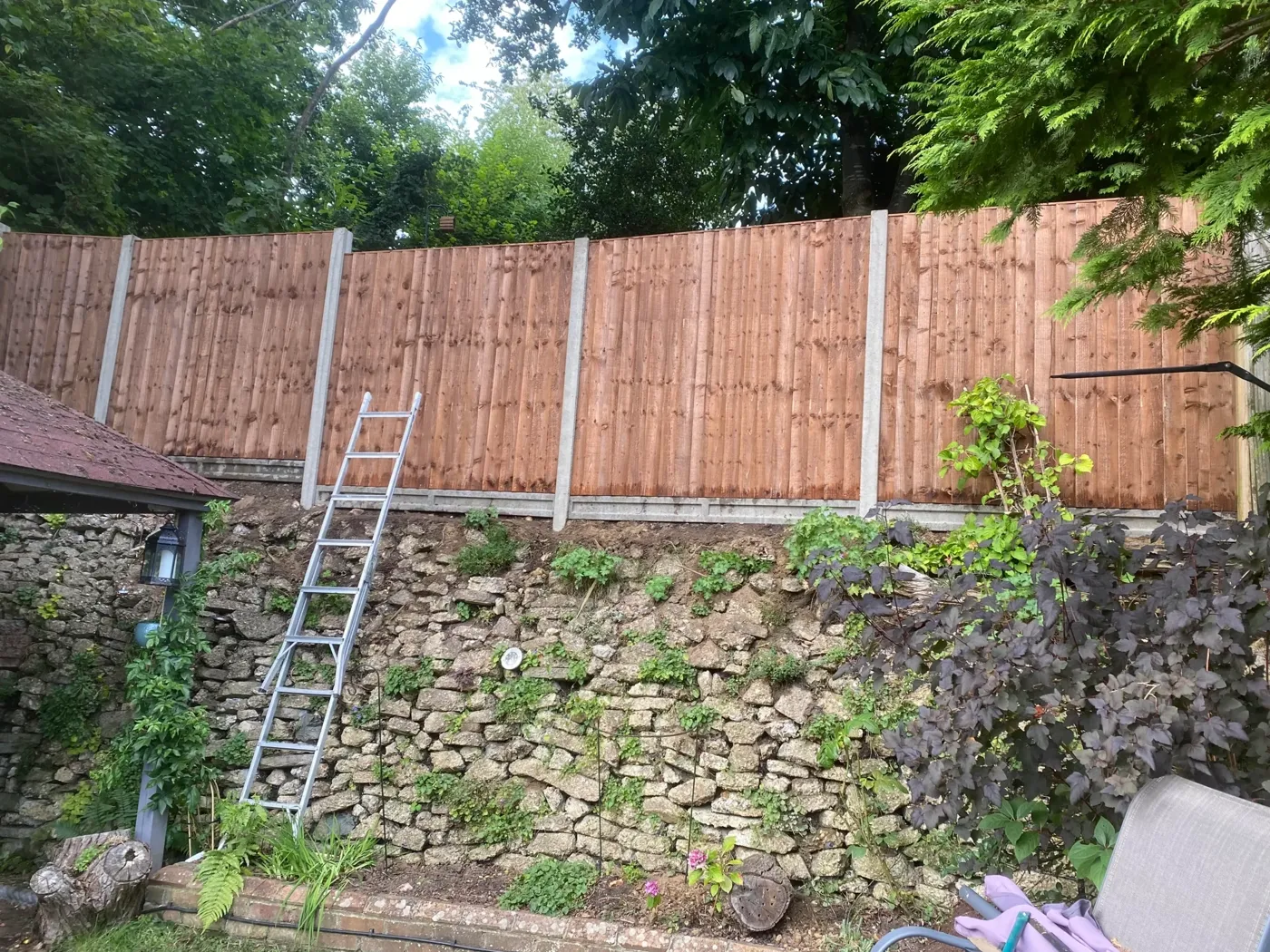 Finished timber fence line beside a garden path